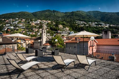 a group of chairs and umbrellas on a roof at Residenze dell'Angelo in Locarno