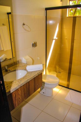 a bathroom with a sink and a toilet and a shower at Terras Hotel in Lucas do Rio Verde