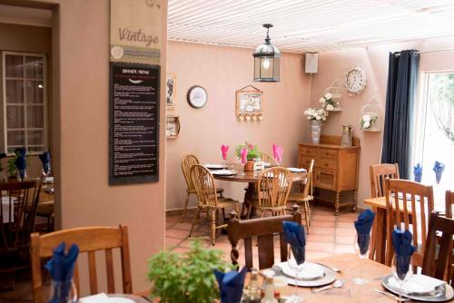 a dining room with a table and chairs in a restaurant at Greenfields Guesthouse & Restaurant in Alberton