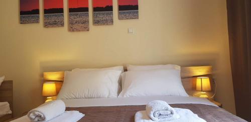 a bedroom with a bed with towels on it at City's Center Lux. Apt.Up 6 persons and BBQ in Kavála