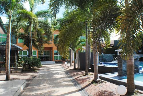 a resort with palm trees and a swimming pool at Joah Inn Appartementen in Paramaribo