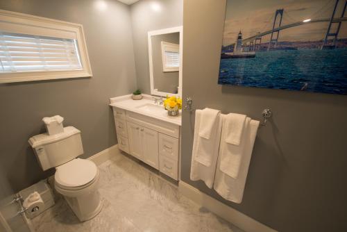 a bathroom with a white toilet and a sink at The Outlook Inn in Newport