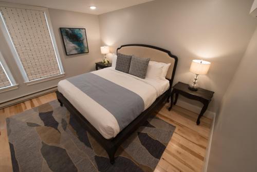 a bedroom with a bed with two night stands and two lamps at The Outlook Inn in Newport