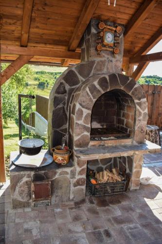 a stone oven with a clock on top of it at Pensiunea Bogas in Praid