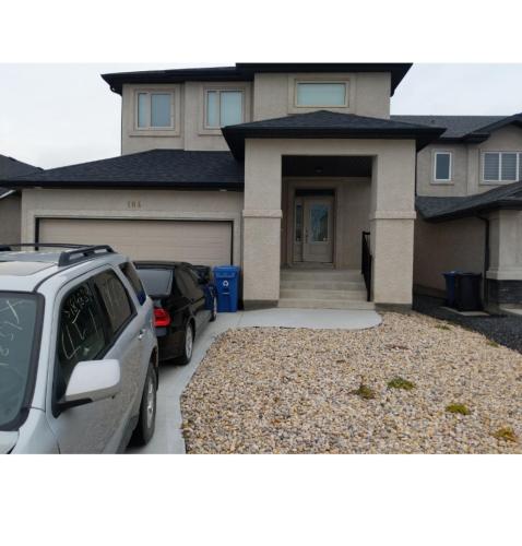a house with a car parked in front of it at The Home Sweet Home in Winnipeg