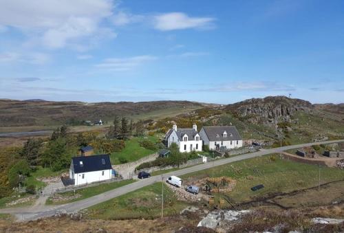 an aerial view of a house and a road at Cruachan Guest House in Stoer