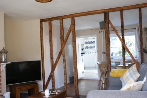 a living room with wooden beams at Wayside Cottage in Saint Osyth