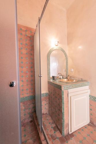 a bathroom with a sink and a mirror at Riad Dar Nawfal in Sale