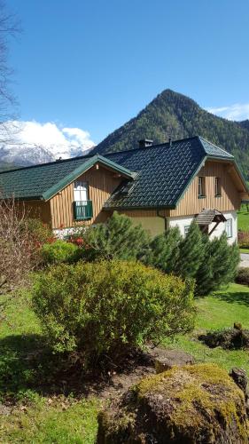 a house with christmas trees in front of it at Ferienhaus Saxenauer in Hinterstoder