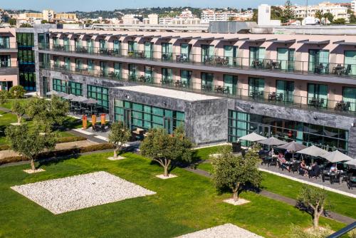 an aerial view of a building with tables and chairs at Vila Gale Lagos in Lagos