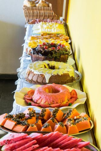 a row of different types of pastries on plates at Pousada Acquarela in Paraty