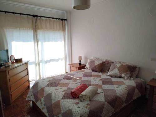a bedroom with a bed with two pillows on it at Rota das praias in Figueira da Foz