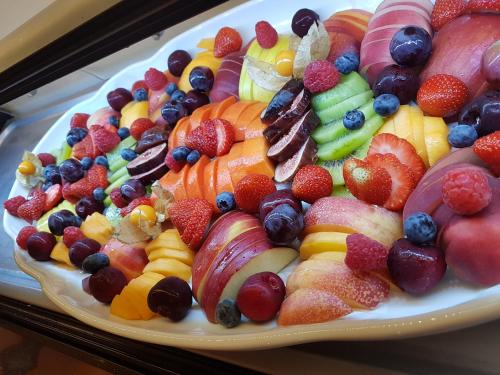 a plate full of fruit on a table at Hostal Casa Mercedes in Nerja
