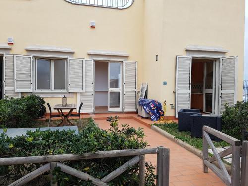a building with a patio with a table and chairs at Rocky & Lia in Bacoli