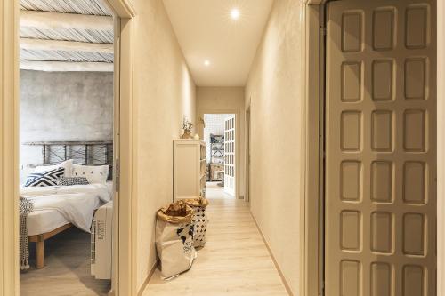 a hallway with a bedroom with a bed and a door at B&B I Cinque Mori in Baunei
