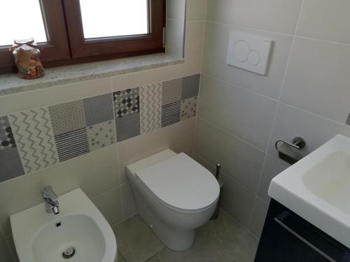 a bathroom with a toilet and a sink at Lagrange 23 in Cambiano