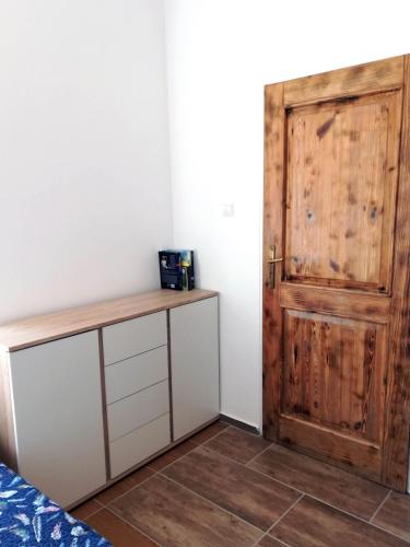a room with a wooden door and a wooden table at Złota Leśniczówka in Rydzówka