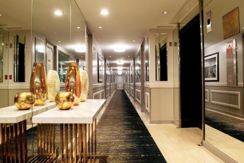 a hallway with vases on display in a building at Club Donatello in San Francisco