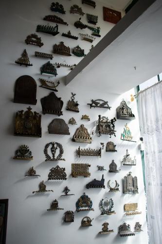 a wall filled with lots of different types of objects at Tzefania Hotel in Jerusalem