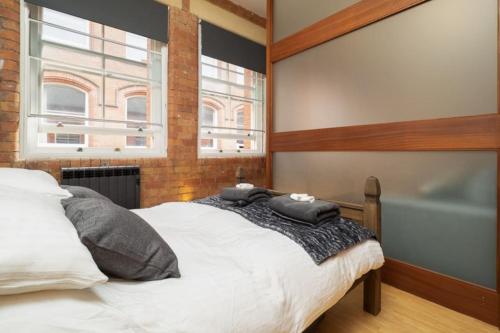 a bedroom with a bed and a bath tub at Stylish and comfortable Lace Market Studio Apartment in Nottingham