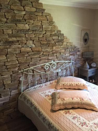 a bed in a room with a brick wall at VILLA PETER in Alexandroupoli