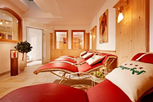 a room with a bunch of red chairs at Hotel Jägerhof in Gerlos