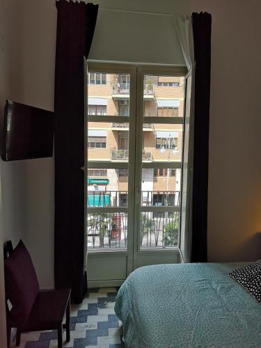 a bedroom with a bed and a large window at Grillo in Salerno