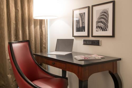 a desk with a laptop and a red chair at Club Donatello in San Francisco