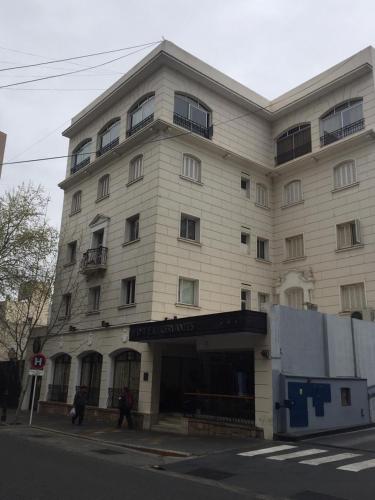 a large white building on the corner of a street at Hotel Cervantes in Mendoza