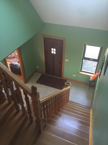 a room with a staircase with a bed in it at Bealaha House in Doonbeg