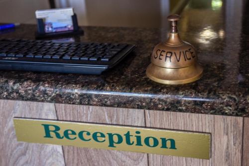 a sign that says recovery and a keyboard on a desk at Aarondale Guest House in Hartlepool