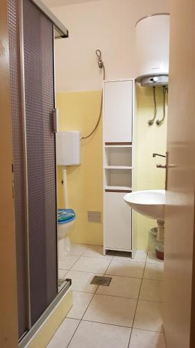 a small bathroom with a sink and a toilet at Apartment Katica in Crikvenica