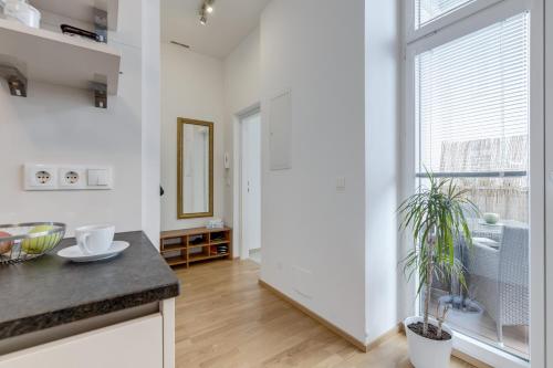 a kitchen with white walls and a large window at Modern Vienna in Vienna