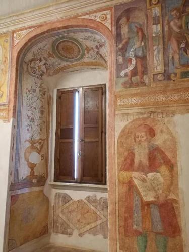 a room with paintings on the wall and a window at Milleunastella in Montescaglioso