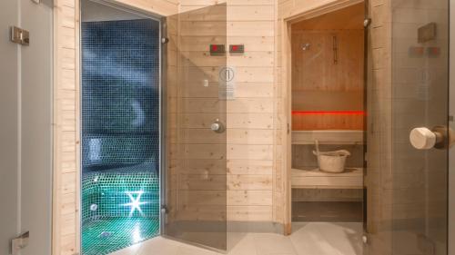 a shower with a glass door in a bathroom at EGH Waterlane Island Apartment in Gdańsk