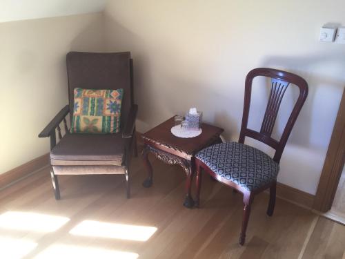 a room with two chairs and a table with a box on it at Bealaha House in Doonbeg