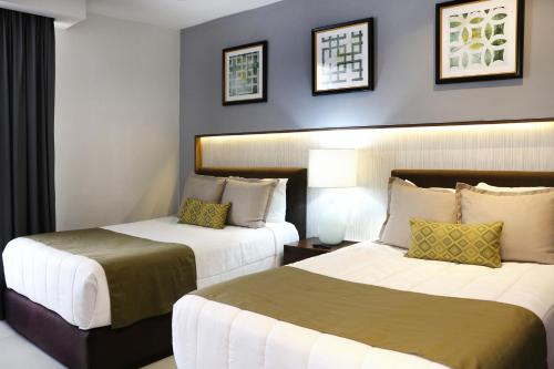 a hotel room with two beds in a room at The Inn at Mazatlan in Mazatlán