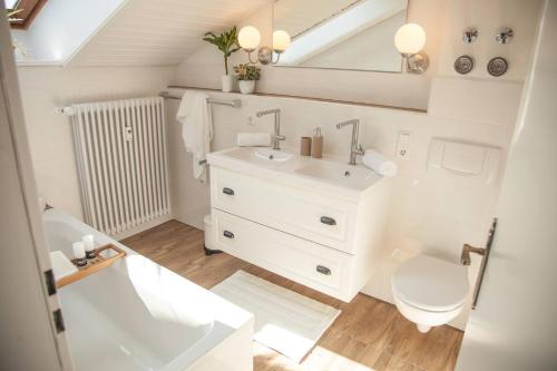 uma casa de banho com um lavatório branco e um WC. em Apartment JoniFee am Titisee em Titisee-Neustadt
