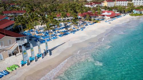 an aerial view of a beach with chairs and the ocean at Pineapple Beach Club - All Inclusive - Adults Only in Willikies