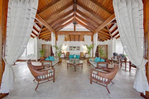 an open living room with chairs and a table at Pineapple Beach Club - All Inclusive - Adults Only in Willikies