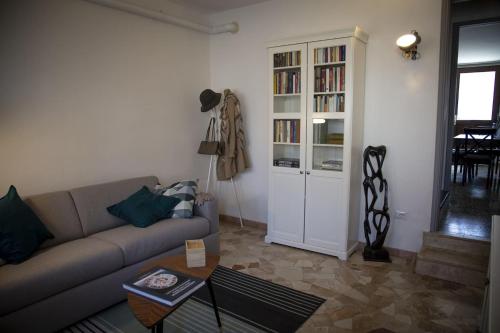 a living room with a couch and a book shelf at La Casa di Luna in Borghetto Lodigiano