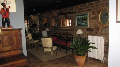 a living room with a couch and chairs and a table at Posada Ormas in Ormas