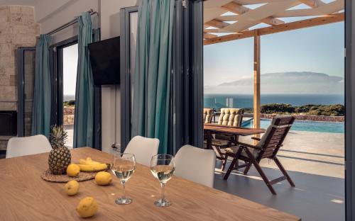 a dining room with a table and a view of the ocean at DaLuz Villa in Koríthion