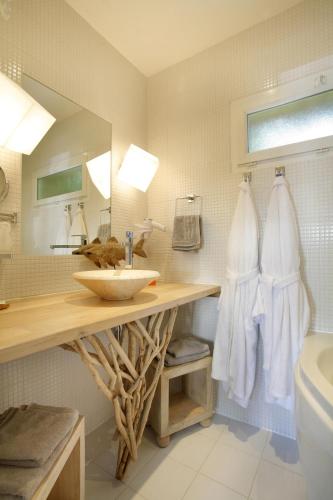 a bathroom with a sink and a mirror at The Originals Hôtel Le Cise Restaurant Chambres et Suites in Ault