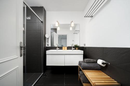 a bathroom with a white sink and a mirror at Beautiful Modern Apartment in Olhão, Algarve in Olhão