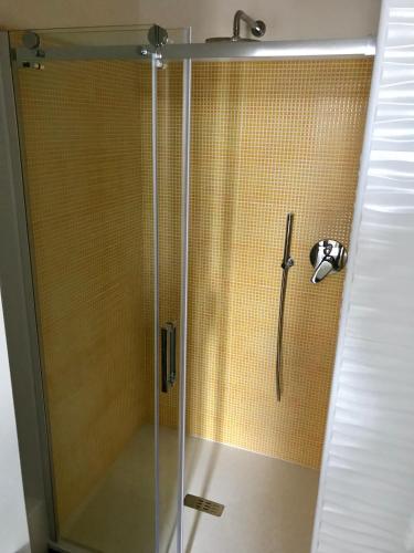 a shower with a glass door in a bathroom at Time Out ApartHotel in Casalecchio di Reno