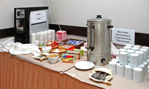 ein Tisch mit Speisen und Getränken und eine Kaffeemaschine in der Unterkunft Hotel Yunona - All Inclusive in Sonnenstrand