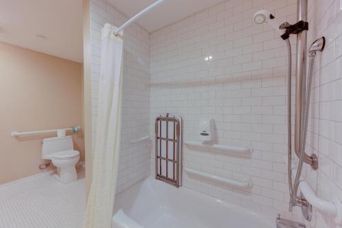 a bathroom with a shower and a toilet at Gaslamp Plaza Suites in San Diego