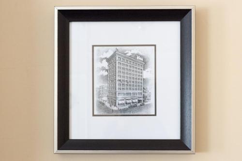 a drawing of a building in a frame on a wall at Gaslamp Plaza Suites in San Diego