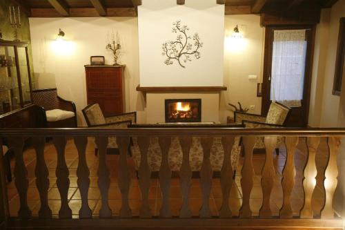 a staircase with a fireplace in a living room at Casa Felisa Pirineo Aragonés in Santa Eulalia de Gállego